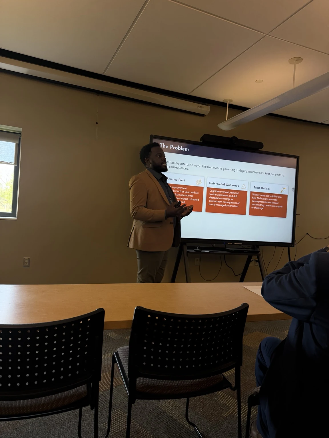 Zirah presenting the Human Impact Measurement Framework to a panel at IBAC 2026